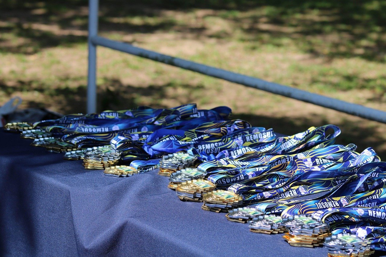 Football medals on a table ready for winners – earn points with every quiz on Certified Casual.