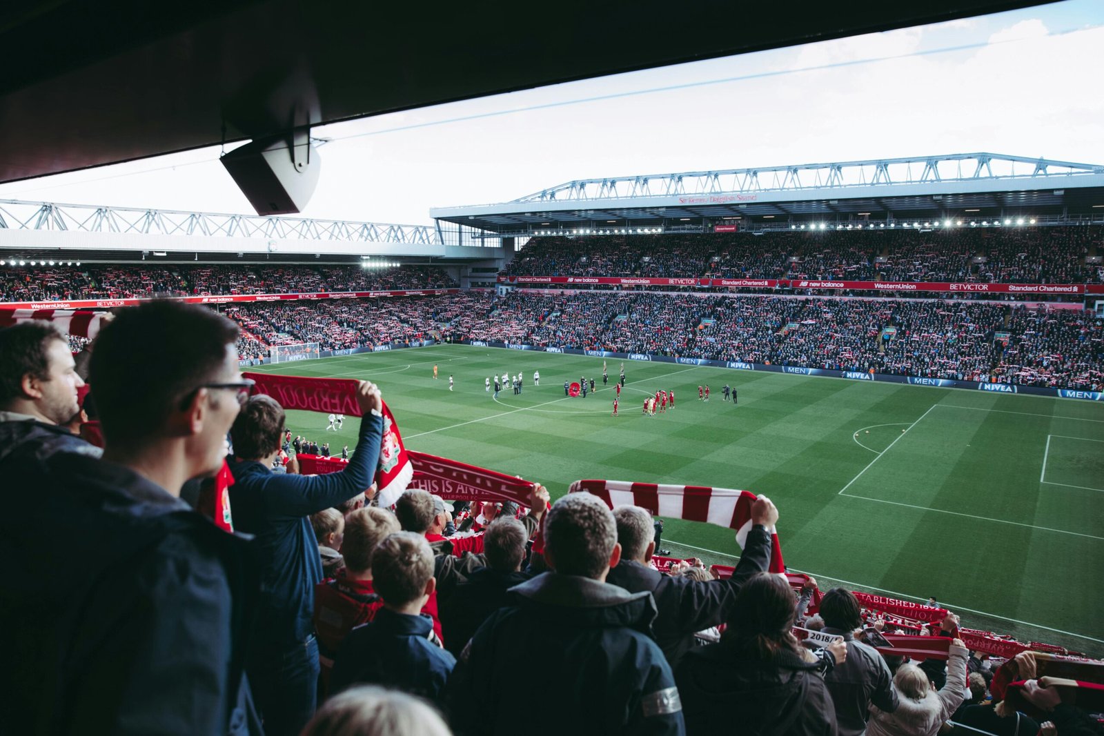 Football fans celebrating in a packed stadium during a match – Certified Casual.